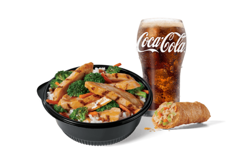 A hearty chicken teriyaki bowl filled with savory grilled chicken, vibrant broccoli, carrots over fried rice, accompanied by a crispy spring roll, and a glass of Coca-Cola with foam on top, set against a clear backdrop for a fulfilling meal.